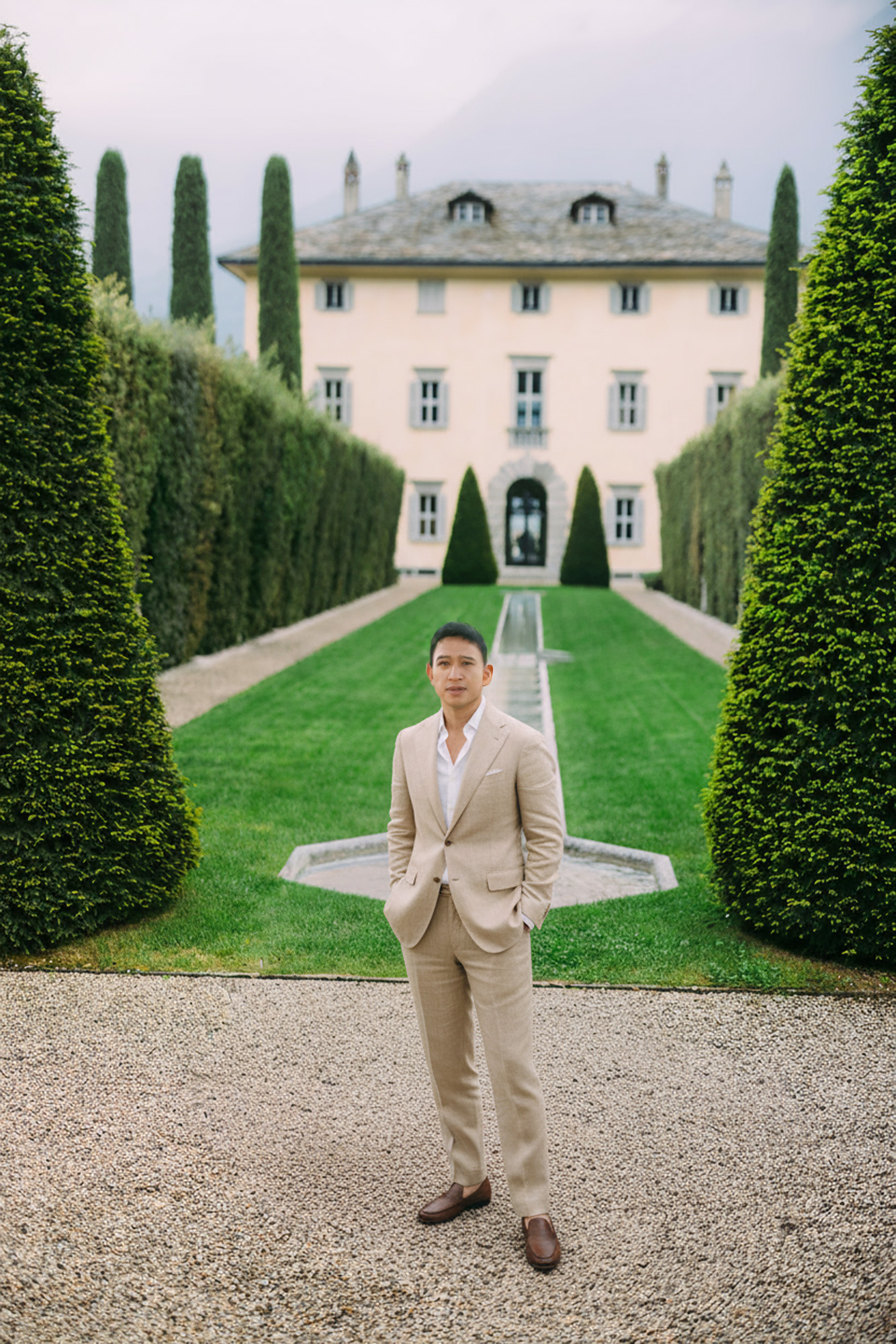 Nat Wongsaroj in a tailored suit in a garden
