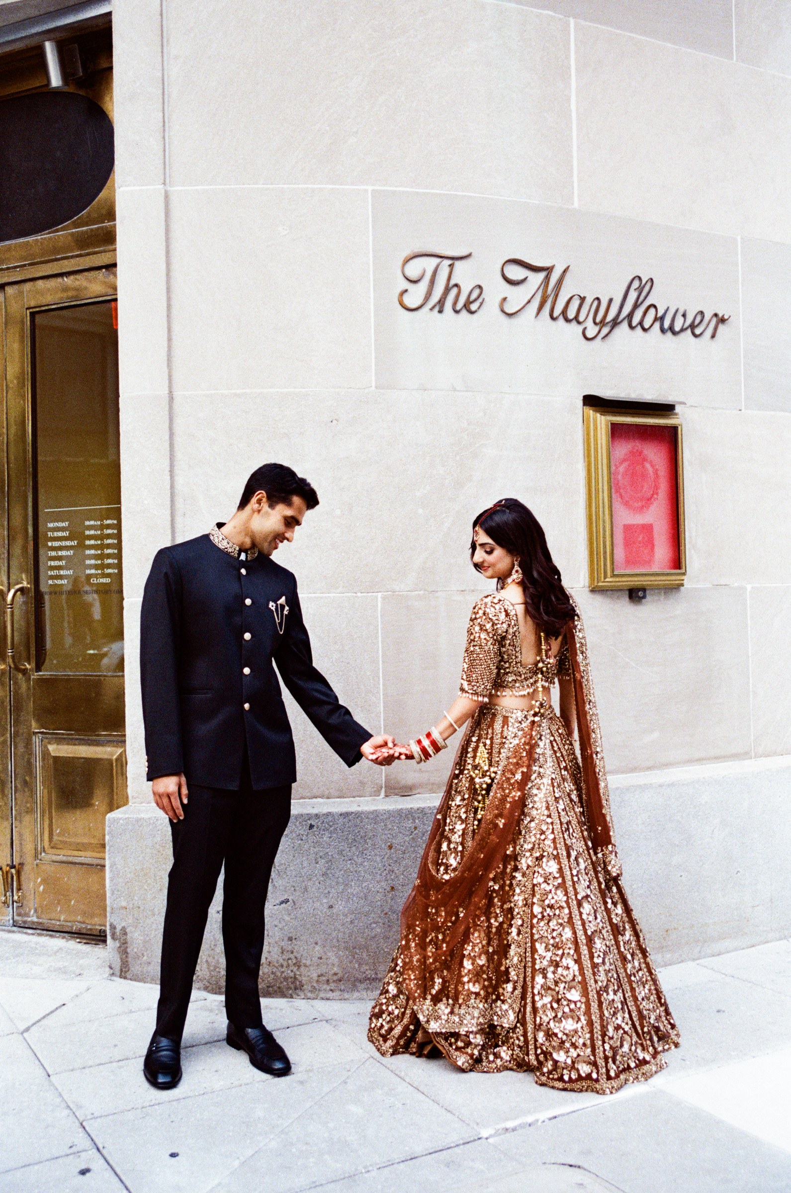 A couple holding hands outside The Mayflower, photographed on 35mm film