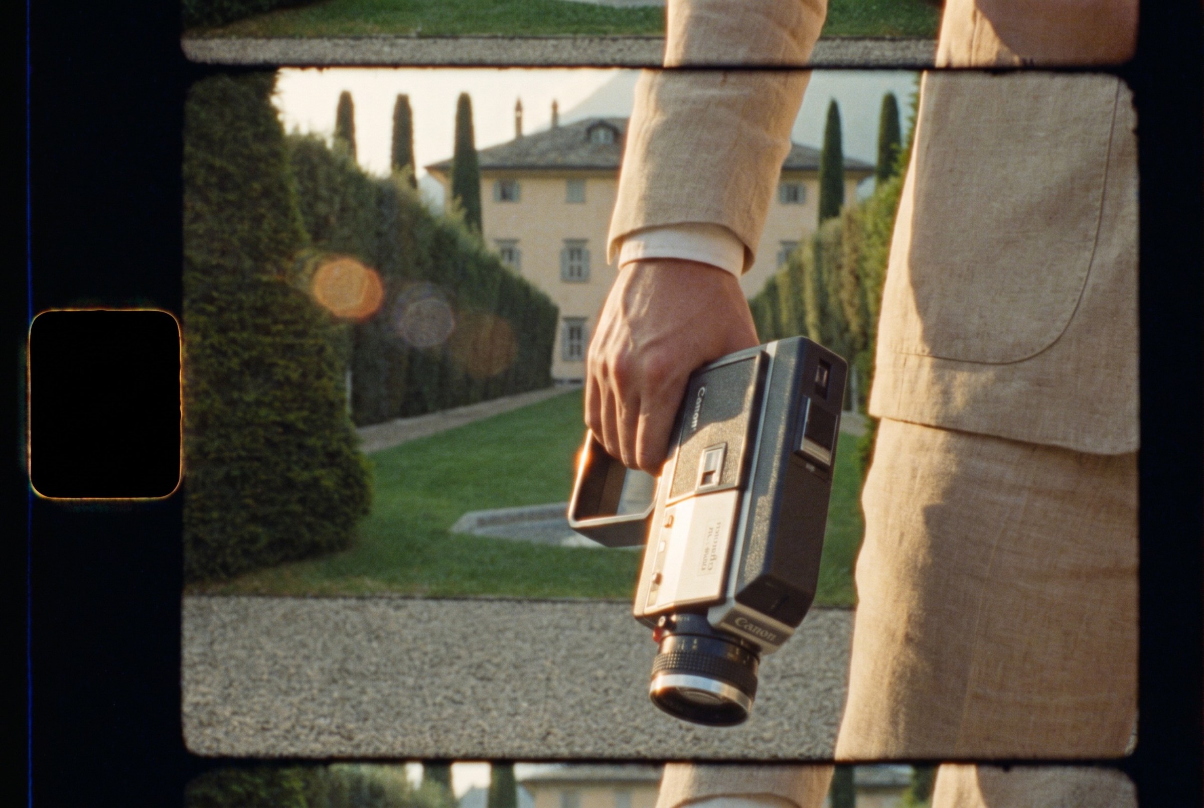 A Super 8 camera carried through a sunlit garden